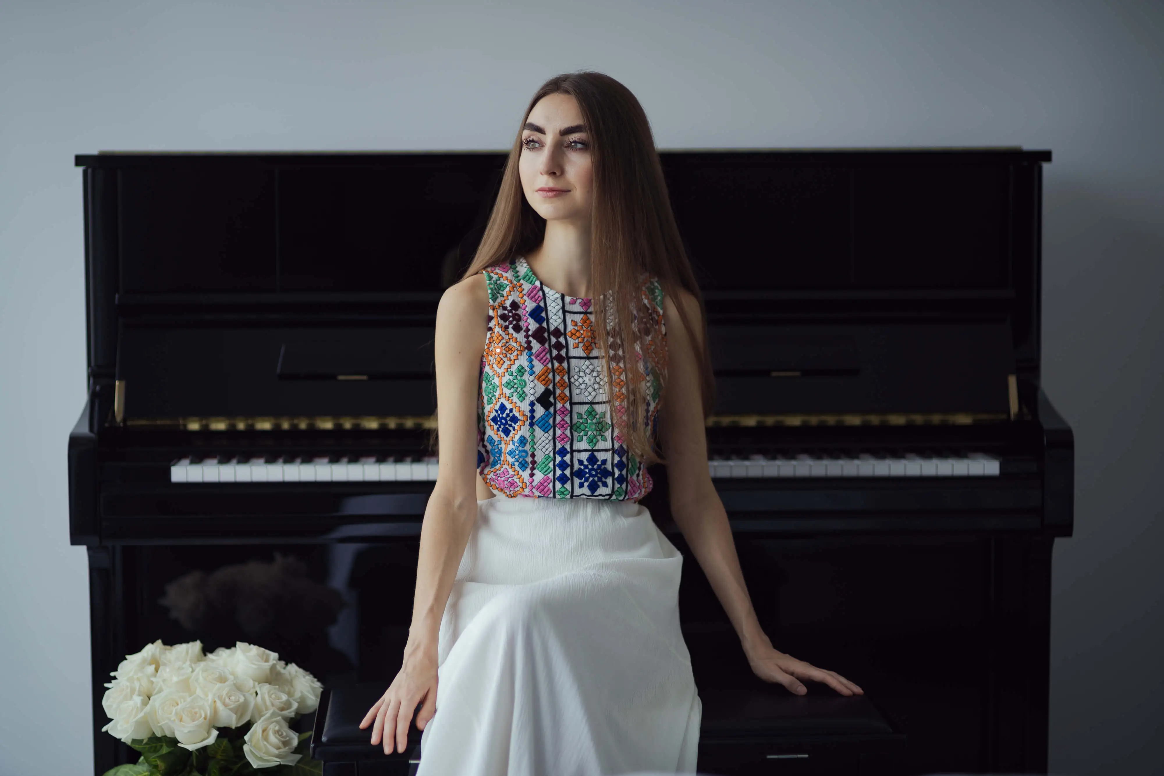 Anastasia Pánik at piano in vyshyvanka